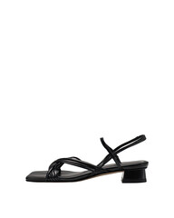 Black sandal with interwoven straps & block heel, against a black backdrop