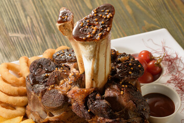 Beef shank on the bone with fermented cabbage, pickled tomatoes, baked potatoes, and teriyaki sauce