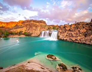 Turquoise waterfall cascading into a serene pool, surrounded by dramatic cliffs
