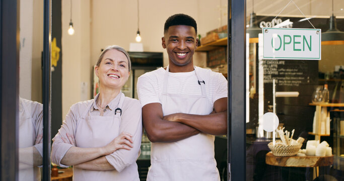 Happy people, portrait and small business with open sign in cafe or ready for service. Man, woman or arms crossed with apron or smile for coffee shop, startup or welcome by front door in restaurant