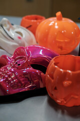 Colorful Halloween masks and decorations, shiny skull mask with pumpkin buckets and costume accessories for spooky holiday celebration