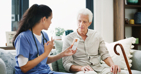 Fototapeta premium Nurse, pills and help with old man on sofa for medical treatment, support or consulting. Medicine, dosage and caregiver with senior patient and woman in living room of home for healthcare advice