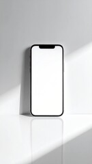 Black smartphone, blank screen, white backdrop