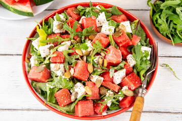 Watermelon salad with feta, arugula, nuts, pumpkin seeds