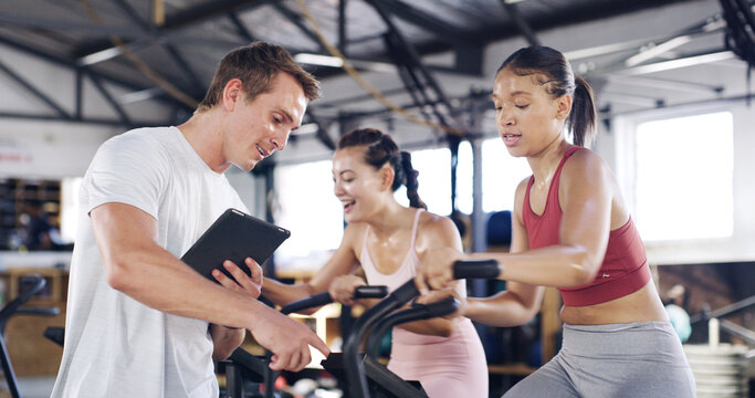 Man, tablet and talking to people in spin class for fitness record, schedule session and progress. Coach, digital app and tracking for cycling exercise, training performance and workout management