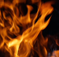 Fototapeta premium The image is of a flame with orange and yellow colors