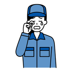 泣くつなぎ作業服の女性