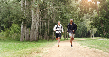 Running, morning and couple in forest for fitness, exercise and cardio workout together outdoor. Nature, hiking trail and happy man and woman training for wellness, health and challenge for hobby