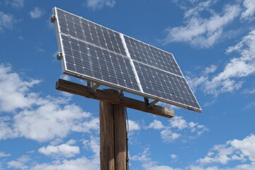 Solar Panel Pole Mount. Renewable Energy Concept with Sunlit Sky Background