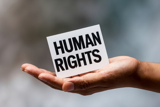 Postcard International Human Rights Day, person holds poster in hand with inscription AI Generative