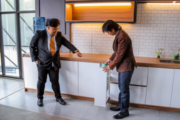 Portrait Of Two Young Asian Male Wearing Suits Take A Break After Work