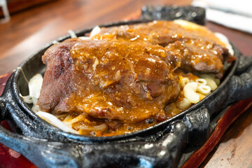 Taiwanese style sizzling beef steak with noodles, egg and black pepper sauce.