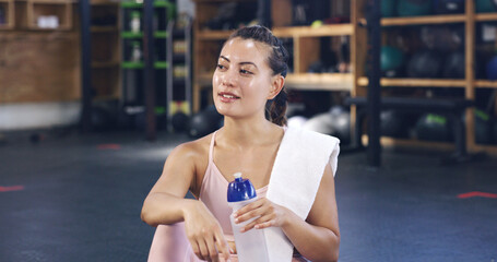 Water, sweat and thinking with woman in gym for electrolytes recovery, workout fatigue and resting....