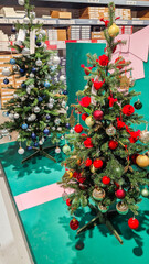 A decorated Christmas trees with various ornaments. The tree features green branches adorned with blue and silver baubles, creating a festive atmosphere.