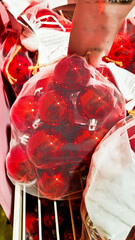 Colorful Christmas decorations including red, white, and blue ornaments, candy canes, and a red paper fan. Perfect for festive holiday settings.