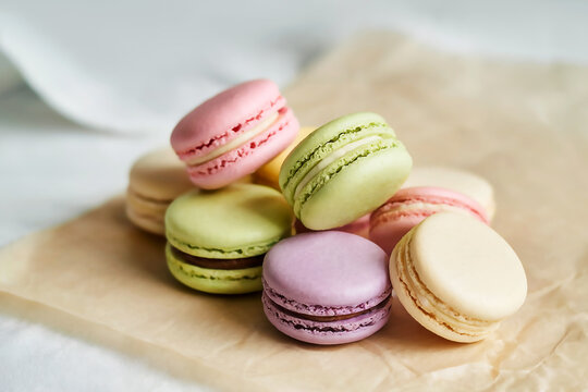 A delightful pile of colorful French macarons on parchment paper