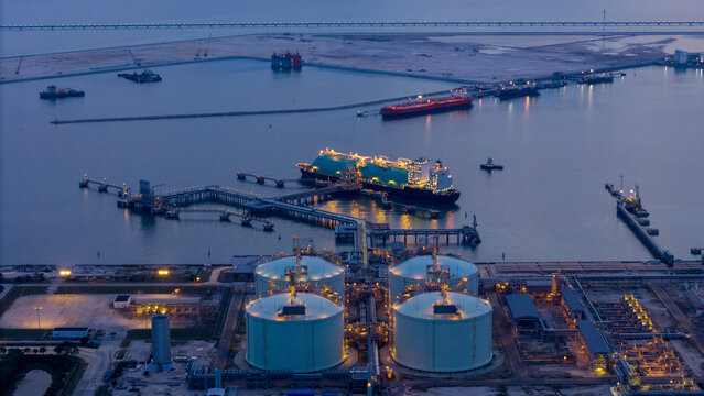 LNG (Liquified Natural Gas) tanker anchored in Gas terminal gas tanks for storage. Oil Crude Gas Tanker Ship. LPG at Tanker Bay Petroleum Chemical or Methane freighter export import transportation