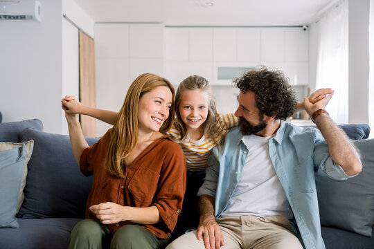 Smiling family hugging and enjoying time together at home