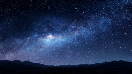 Naklejka premium Vast expanse of the Milky Way galaxy above silhouetted mountain range under a starry night sky