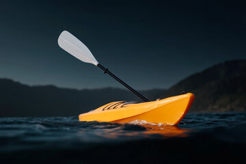 Bright yellow kayak with paddle floating on calm lake at dusk, adventure water sports in mountain landscape with dramatic dark sky