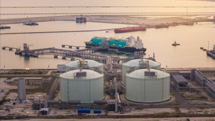 Fototapeta premium LNG (Liquified Natural Gas) tanker anchored in Gas terminal gas tanks for storage. Oil Crude Gas Tanker Ship. LPG at Tanker Bay Petroleum Chemical or Methane freighter export import transportation