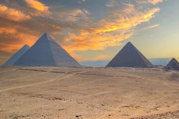pyramids of giza with colorful clouds in the desert