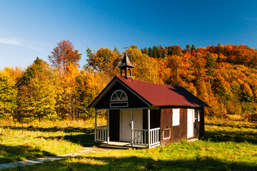 Wooden church in autumn forest, Zagorze Slaskie, Lower Silesia, Poland. 