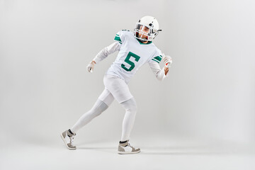 Full-length portrait of American football player in uniform running