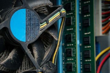 Obraz premium Dusty computer cooling fan and motherboard close up, dirty PC hardware component in need of cleaning and maintenance