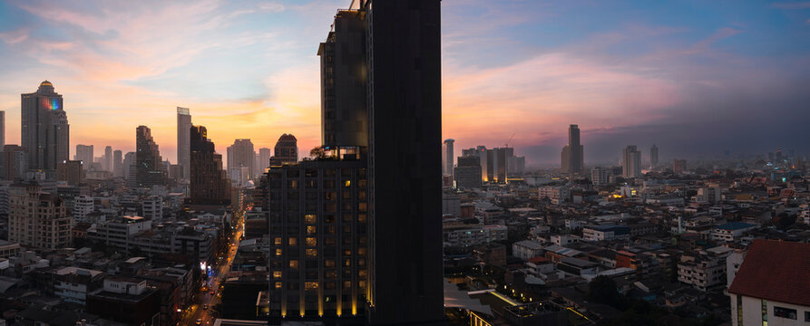 Aerial view of Bangkok city skyline at sunset from rooftop