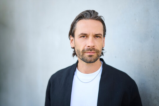 Confident male portrait with eyeglasses in modern urban setting
