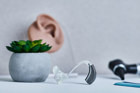 BTE hearing aid stands on audiologist's desk for hearing clinic patient. Hearing solutions