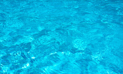 Blue pool water with sun reflections