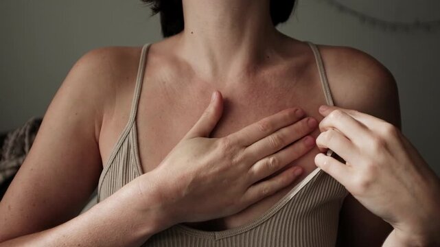 Caucasian woman makes chest massage using moisturizing cream. Manual massage technique. Self care spa procedure at home. Morning ritual.