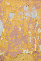 Peeling painted wall showing stucco plaster aging texture
