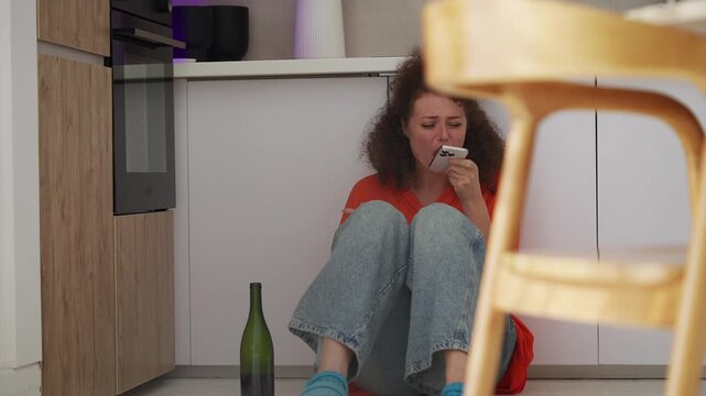 Upset woman crying and calling ex while drinking wine, loneliness and heartbreak