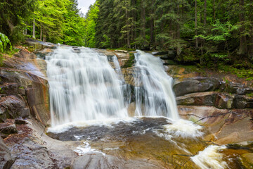 Mumlava waterfall cascading over rocks in Harrachov, Czechia