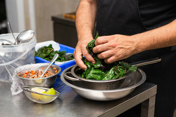 Hands cooking in restaurant kitchen