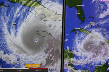 Fototapeta premium Hurricane Melissa shown on screen through windy app. Catastrophic storm towards Jamaica