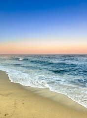 sunset on the beach with waves in corsica