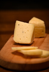 Craft cheese cut into pieces on a cutting board