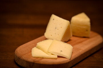 Craft cheese cut into pieces on a cutting board