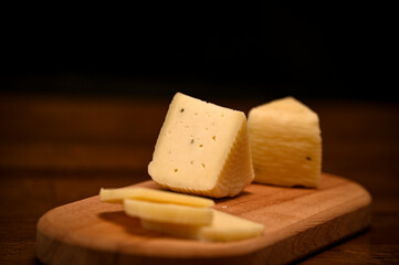 Craft cheese cut into pieces on a cutting board