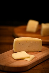 Craft cheese cut into pieces on a cutting board