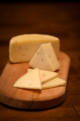 Craft cheese cut into pieces on a cutting board