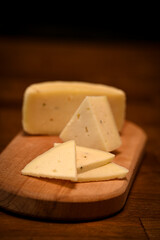 Craft cheese cut into pieces on a cutting board