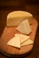 Craft cheese cut into pieces on a cutting board