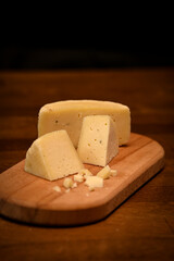 Craft cheese cut into pieces on a cutting board