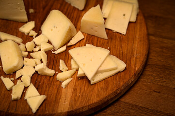 Craft cheese cut into pieces on a cutting board
