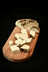 Craft cheese cut into pieces on a cutting board